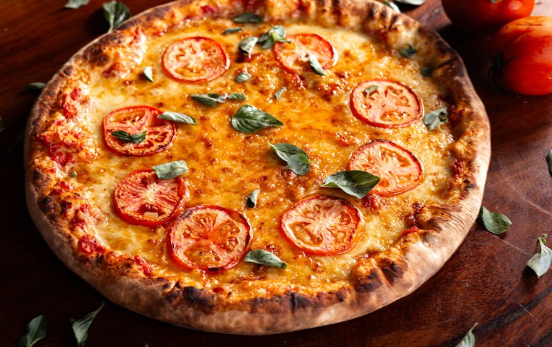 Pizza dough being stretched by hand at mod pizza kitchen