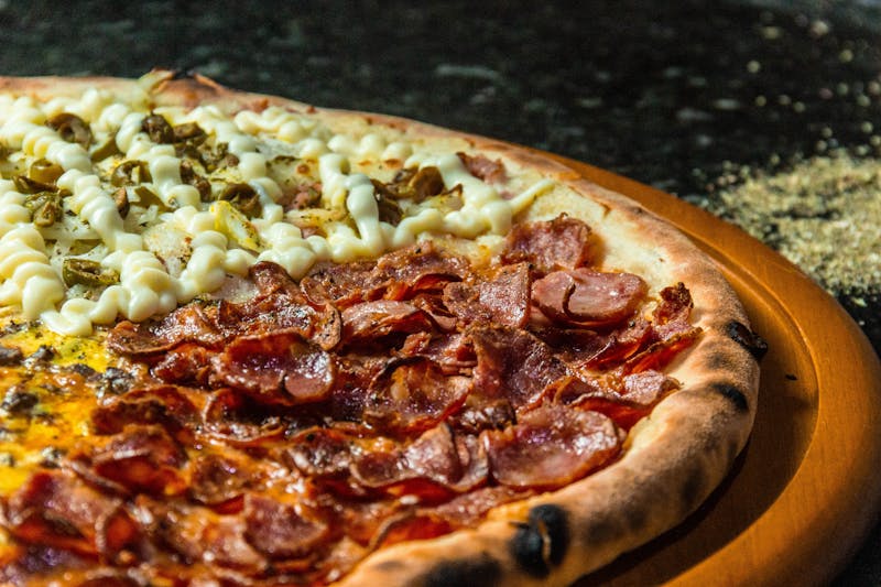 mods pizza topped with colorful fresh vegetables and cheese